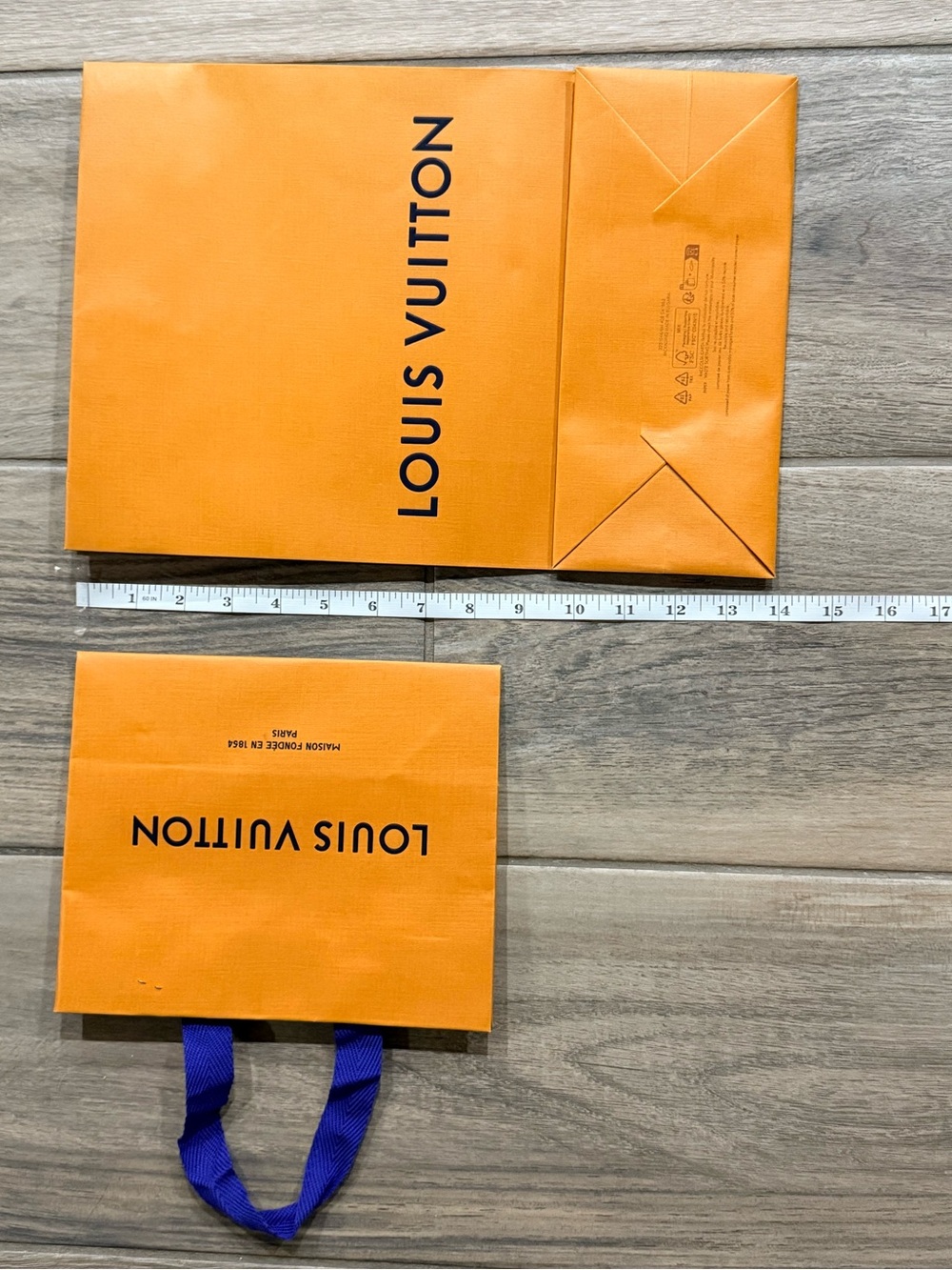 Two Louis Vuitton paper shopping bags